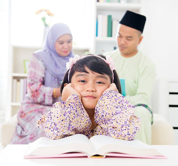 Child reading a storybook at a desk